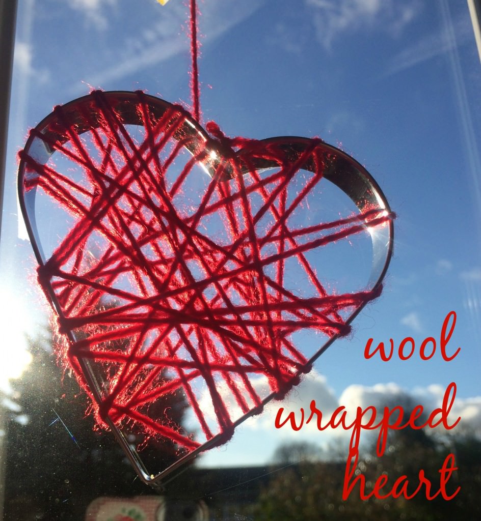 red wool wrapped heart in window