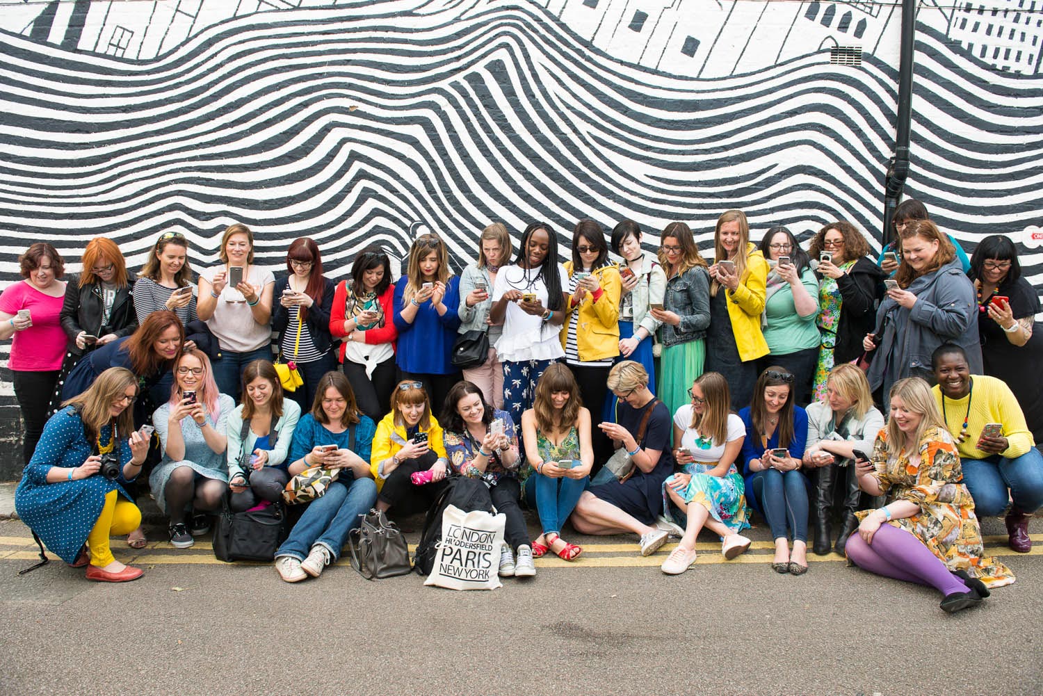 group of Blogtacular attendees in front of a stripey wall