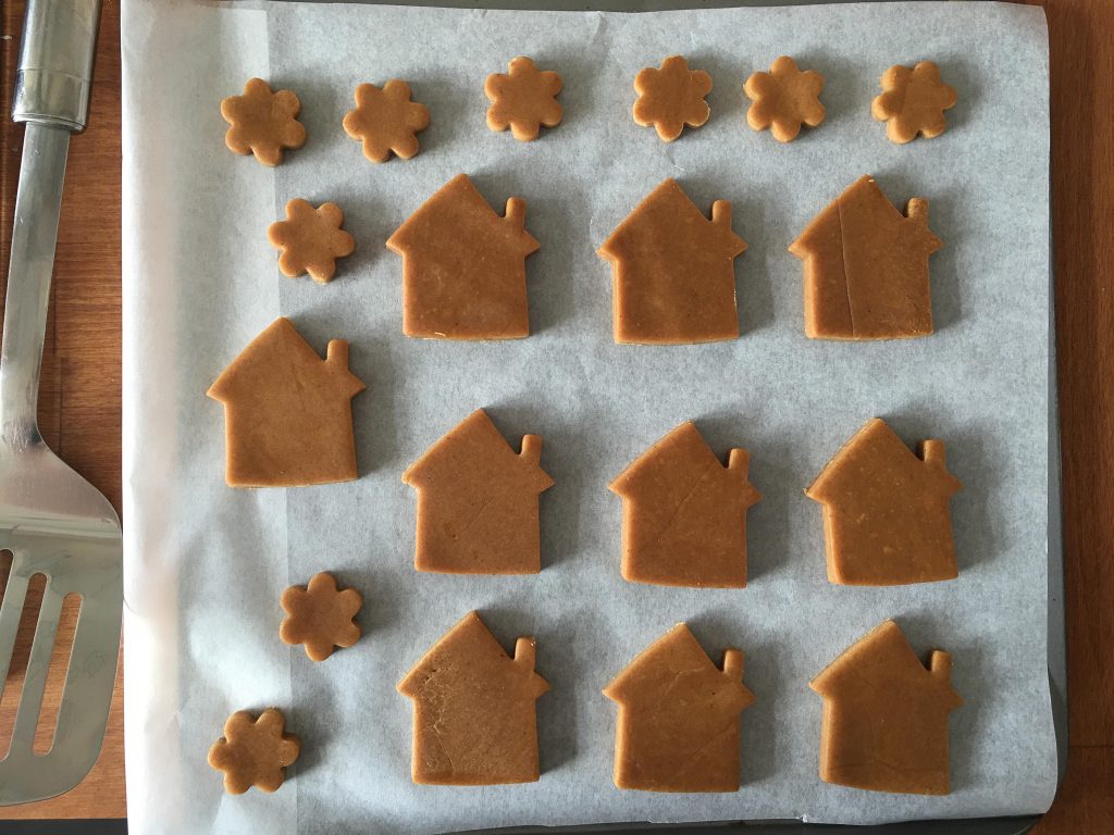 gingerbread house cookies on a baking tray