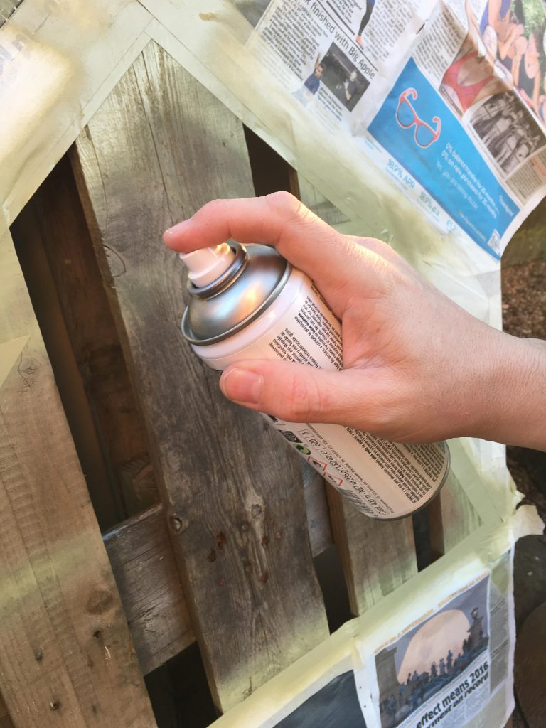 spraying my Pallet Christmas tree