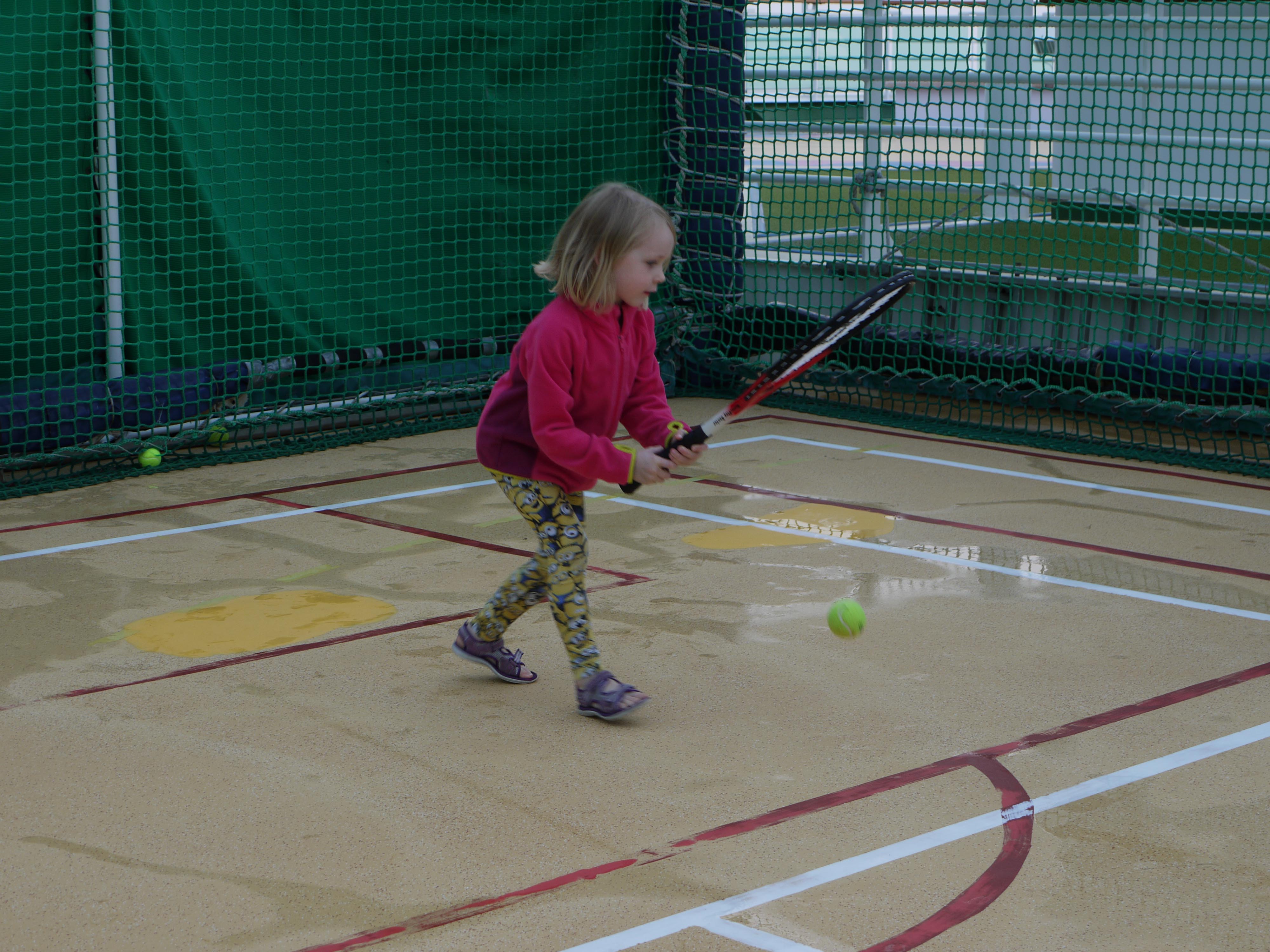 child playing tennis
