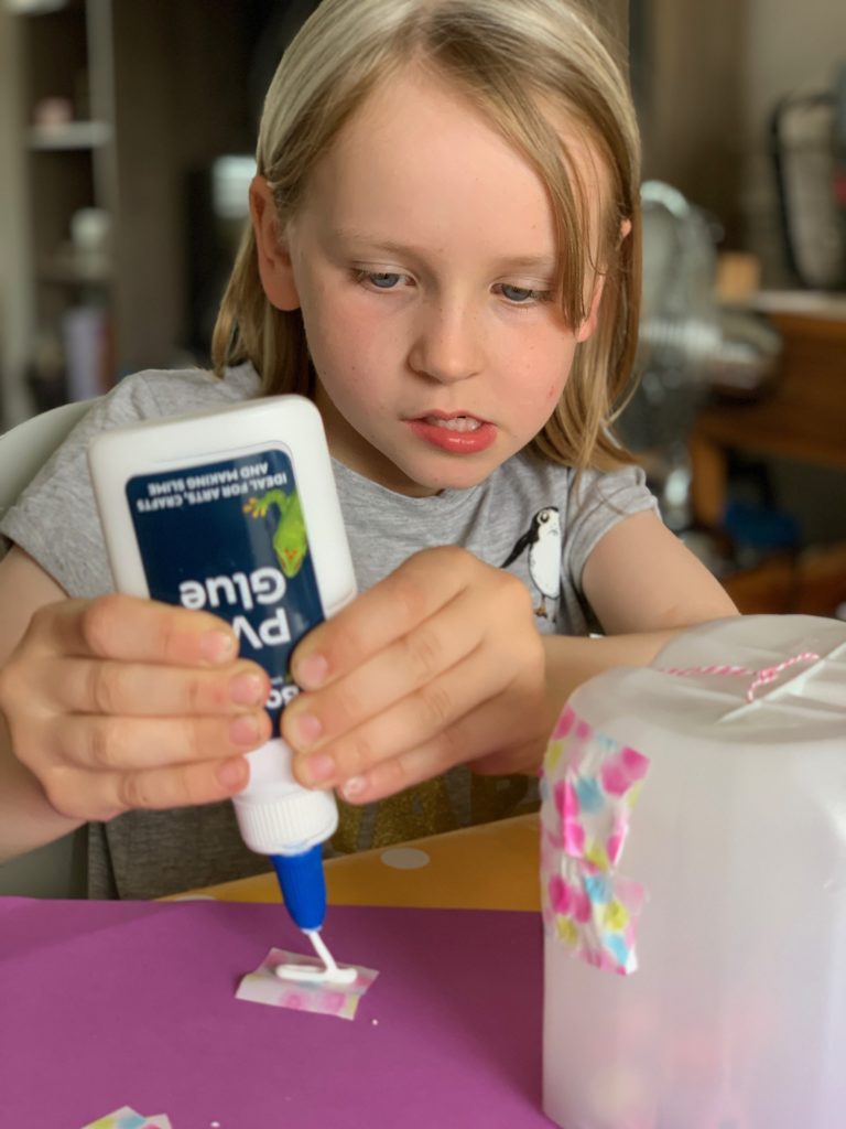 child squeezing glue