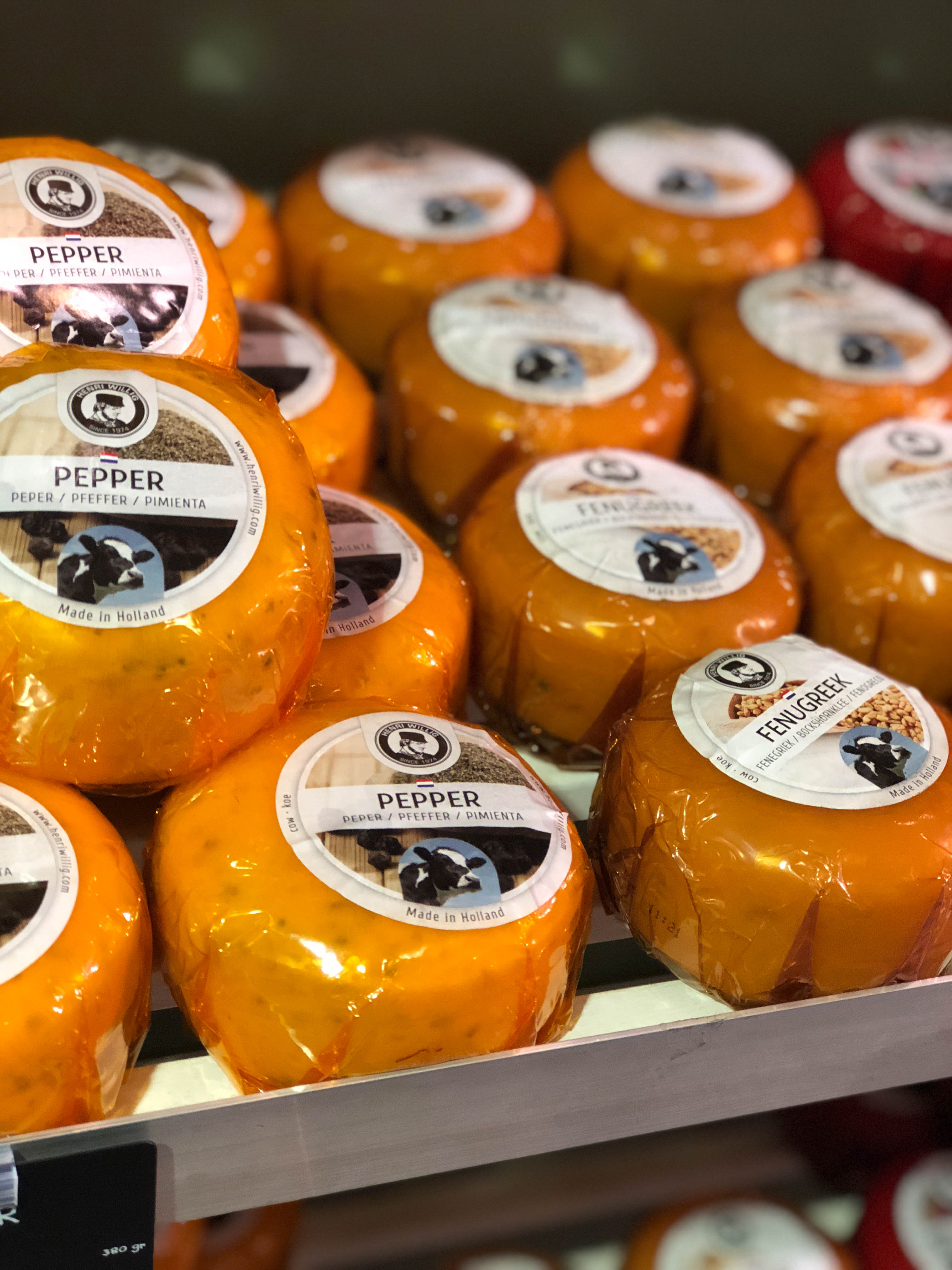 shelf of Dutch cheeses