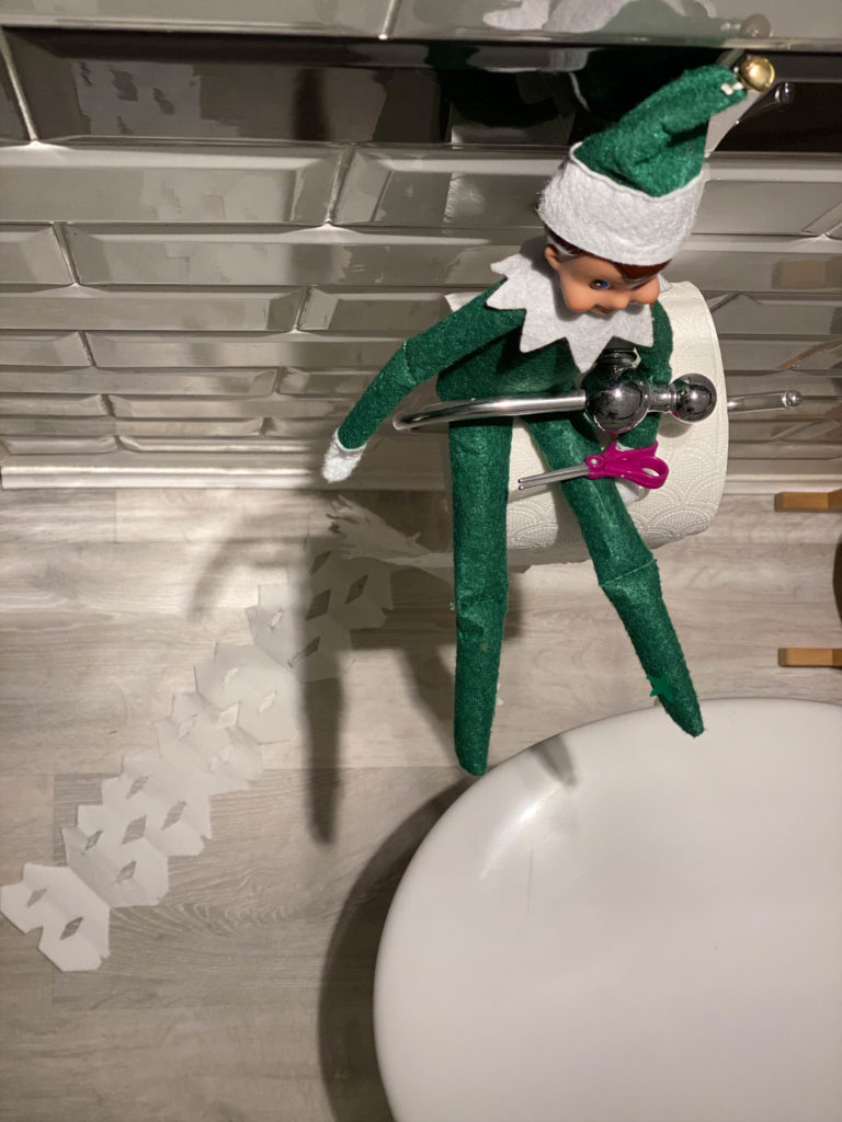 Elf on the Shelf making snowflakes