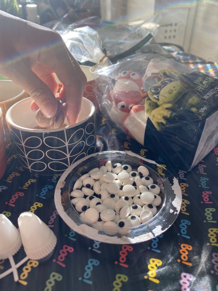 decorating a Halloween gingerbread house