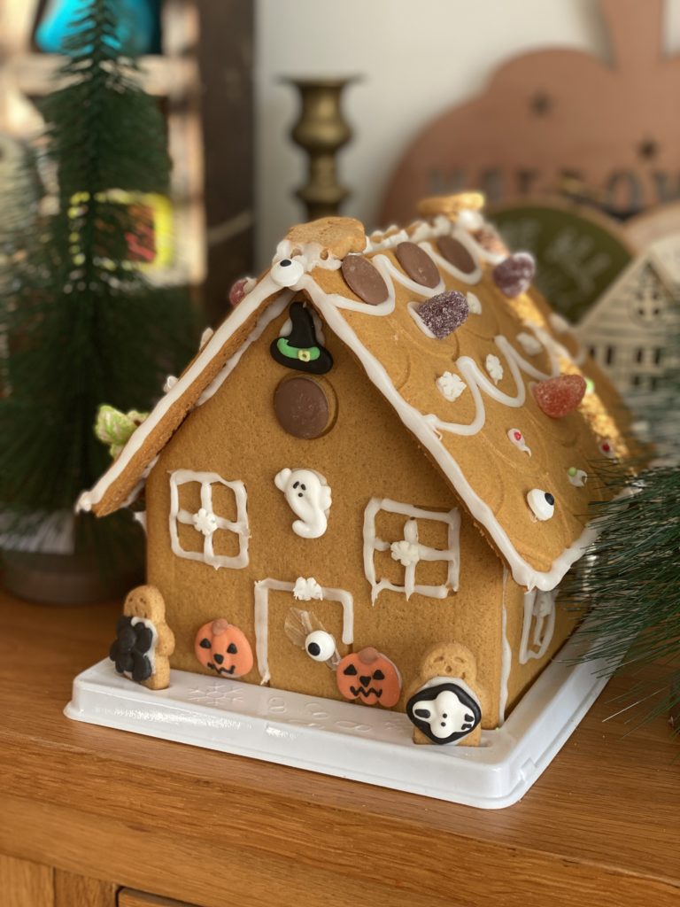 decorating a gingerbread house for Halloween